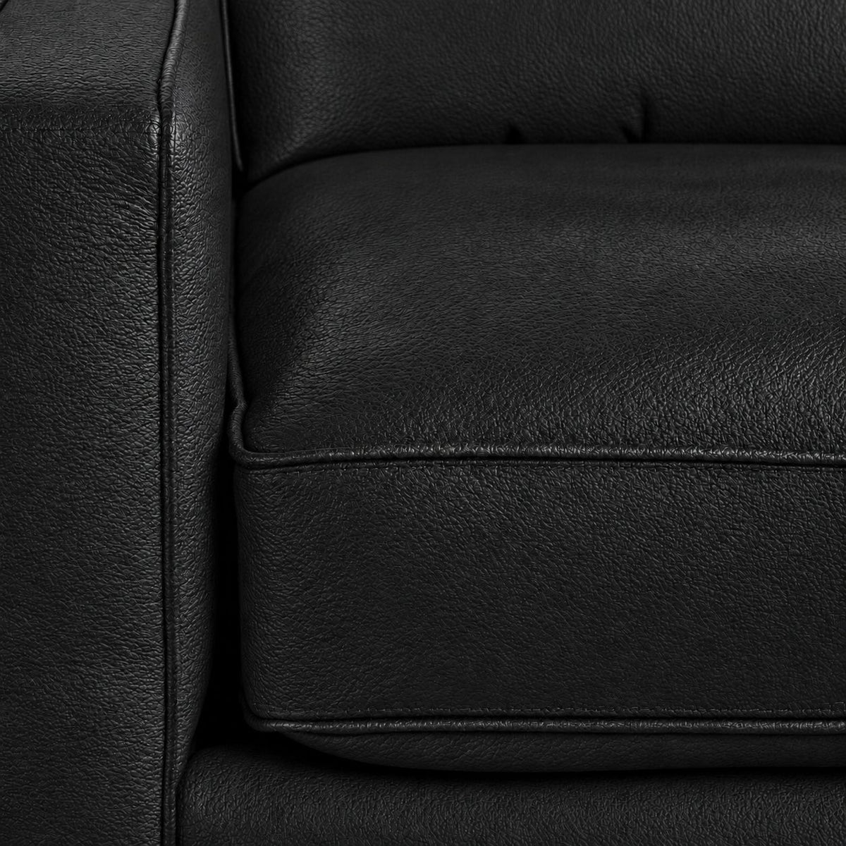Close-up of the City Leather collection in Black showing textured leather upholstery, piped cushion edges and stitching