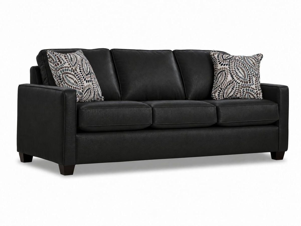 City Leather Sofa - Black in a three-quarter view with three seat cushions, patterned accent pillows and dark wood legs