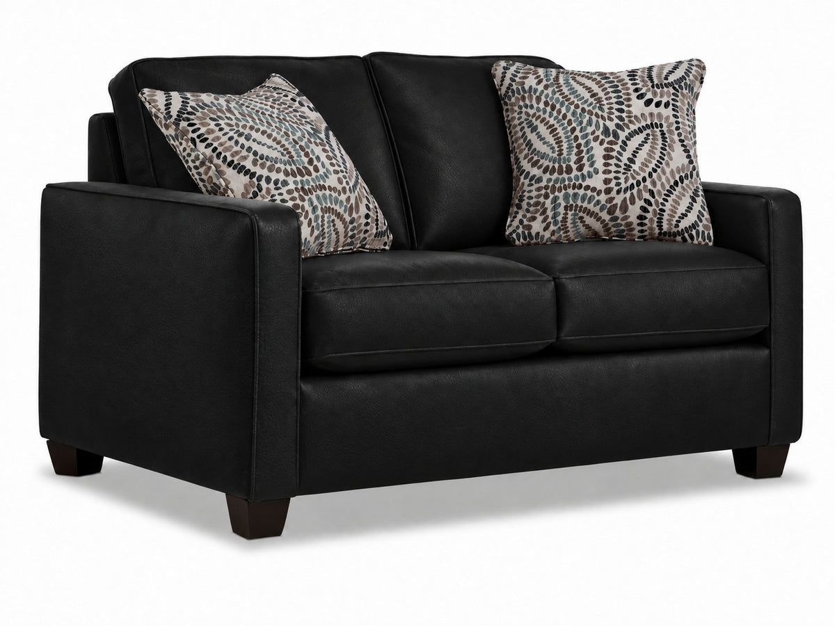 City Leather Loveseat - Black in a three-quarter view with two seat cushions, patterned accent pillows and dark wood legs