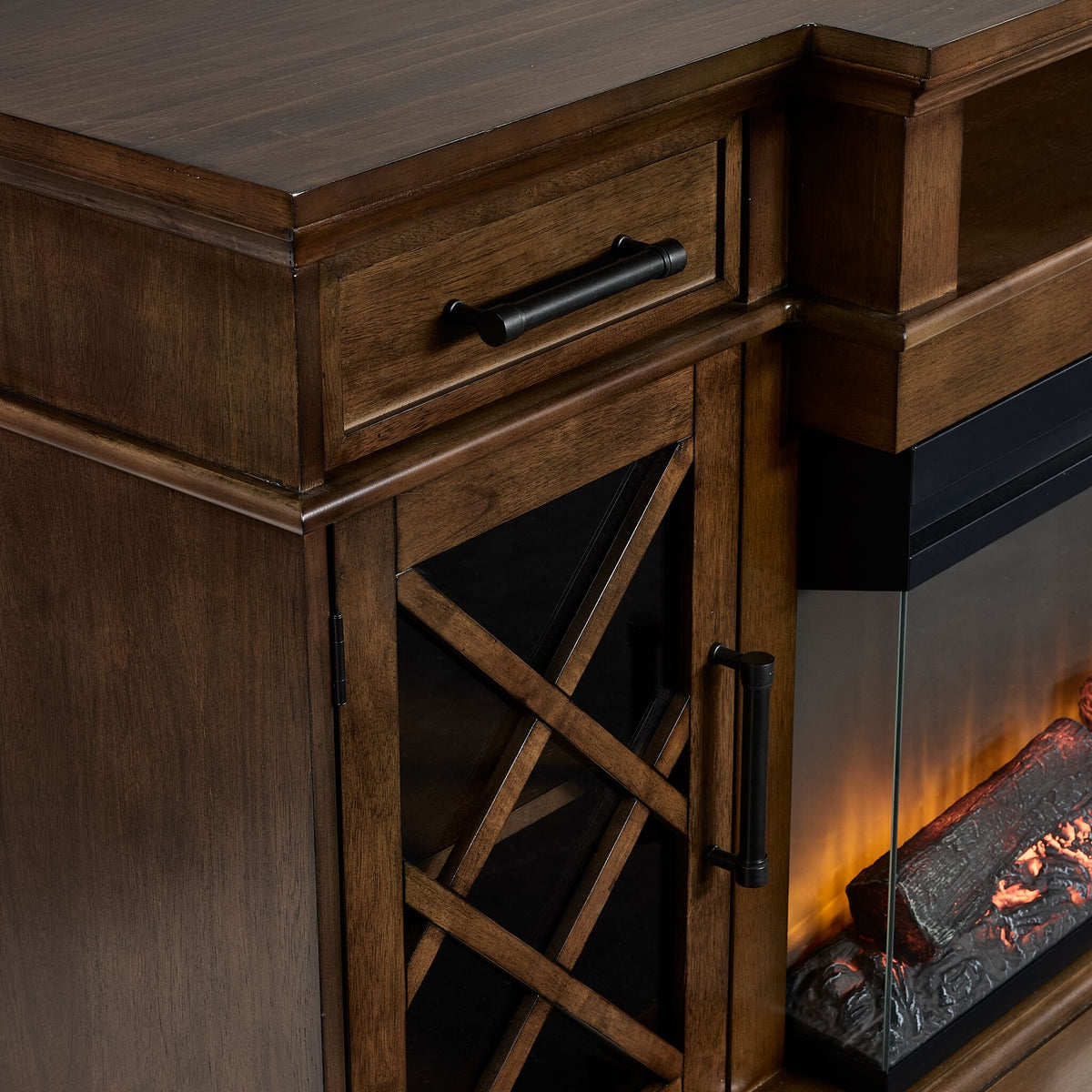 Close-up of Cardiff 70" Fireplace TV Stand - Walnut showing wood grain, black hardware and cross-pattern cabinet door