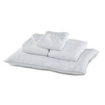 Twin 7-Piece White Dream Bedding Bundle with white pillows, folded bedding and sleep mask arranged together