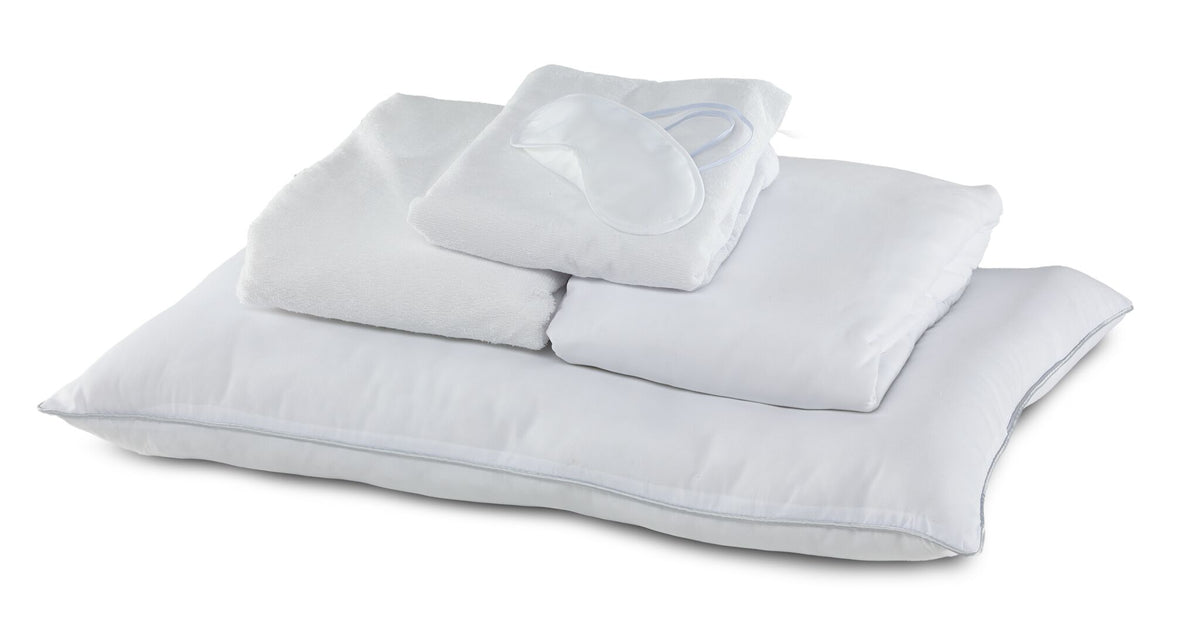 Twin 7-Piece White Dream Bedding Bundle with white pillows, folded bedding and sleep mask arranged together