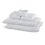 Queen 10-Piece White Dream Bedding Bundle with white pillows, folded bedding and sleep mask arranged together