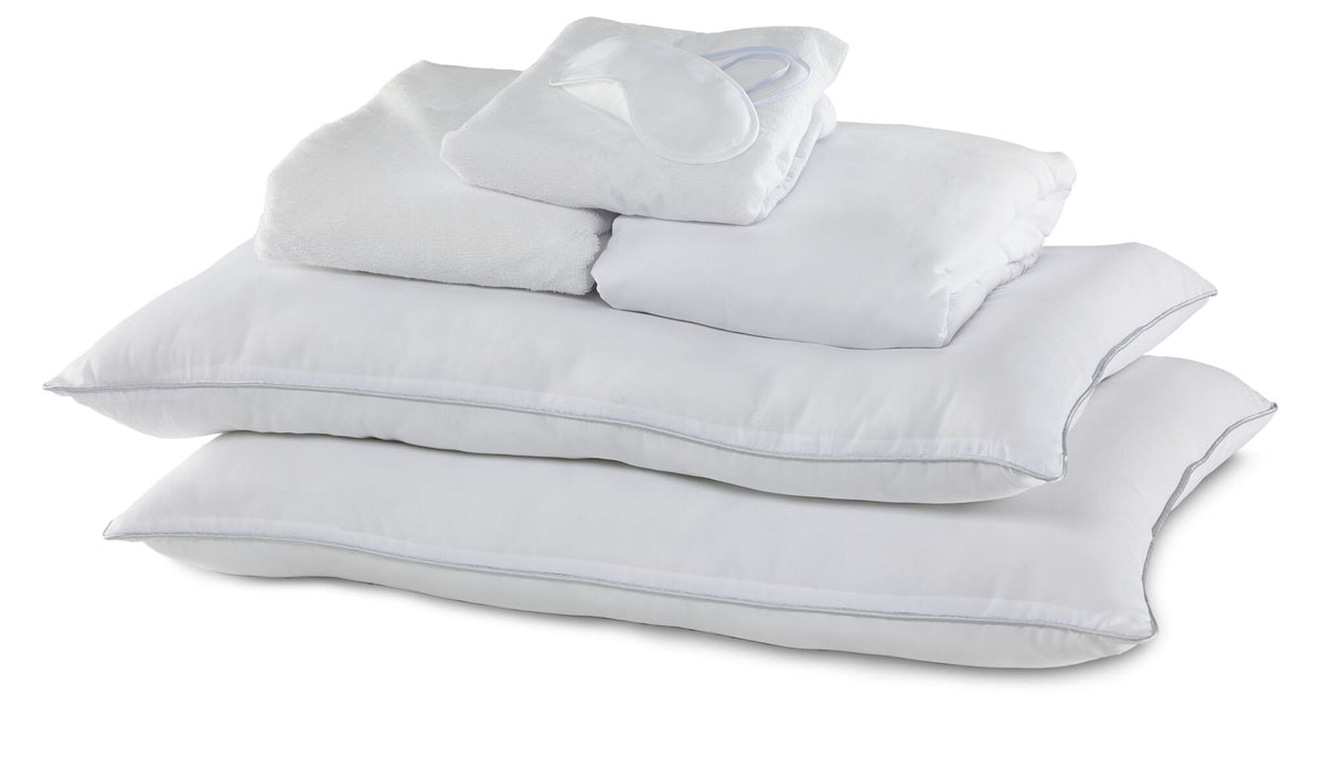 Queen 10-Piece White Dream Bedding Bundle with white pillows, folded bedding and sleep mask arranged together