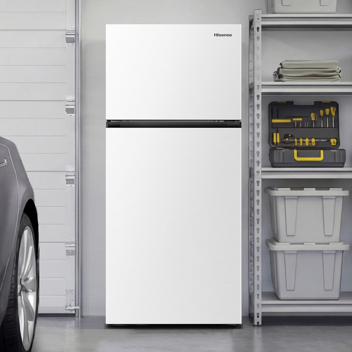 White Hisense top-mount refrigerator shown in a garage beside storage shelves