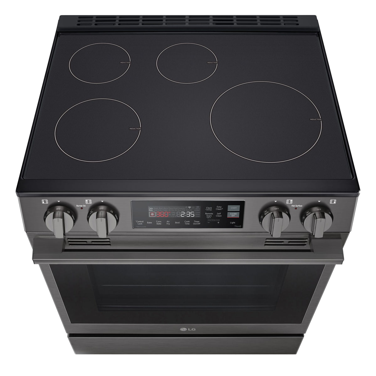 Angled top view of LG induction range showing four cooking zones, front control knobs and digital oven control panel
