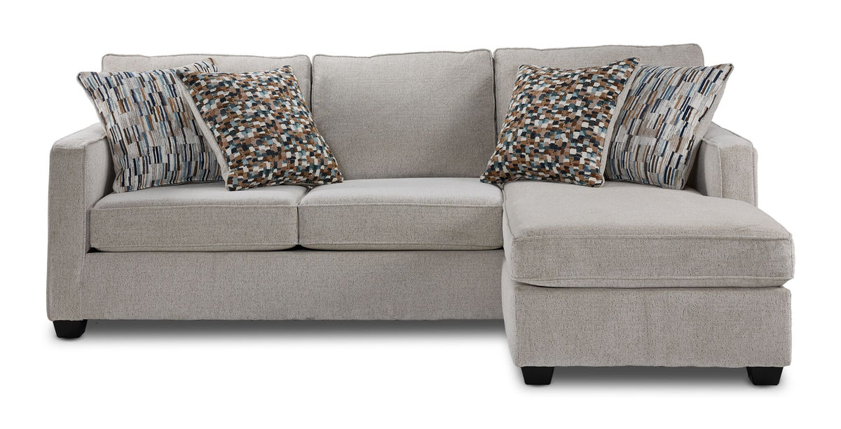 Front view of Laila beige polyester sofa chaise with patterned accent pillows and chaise positioned on the right