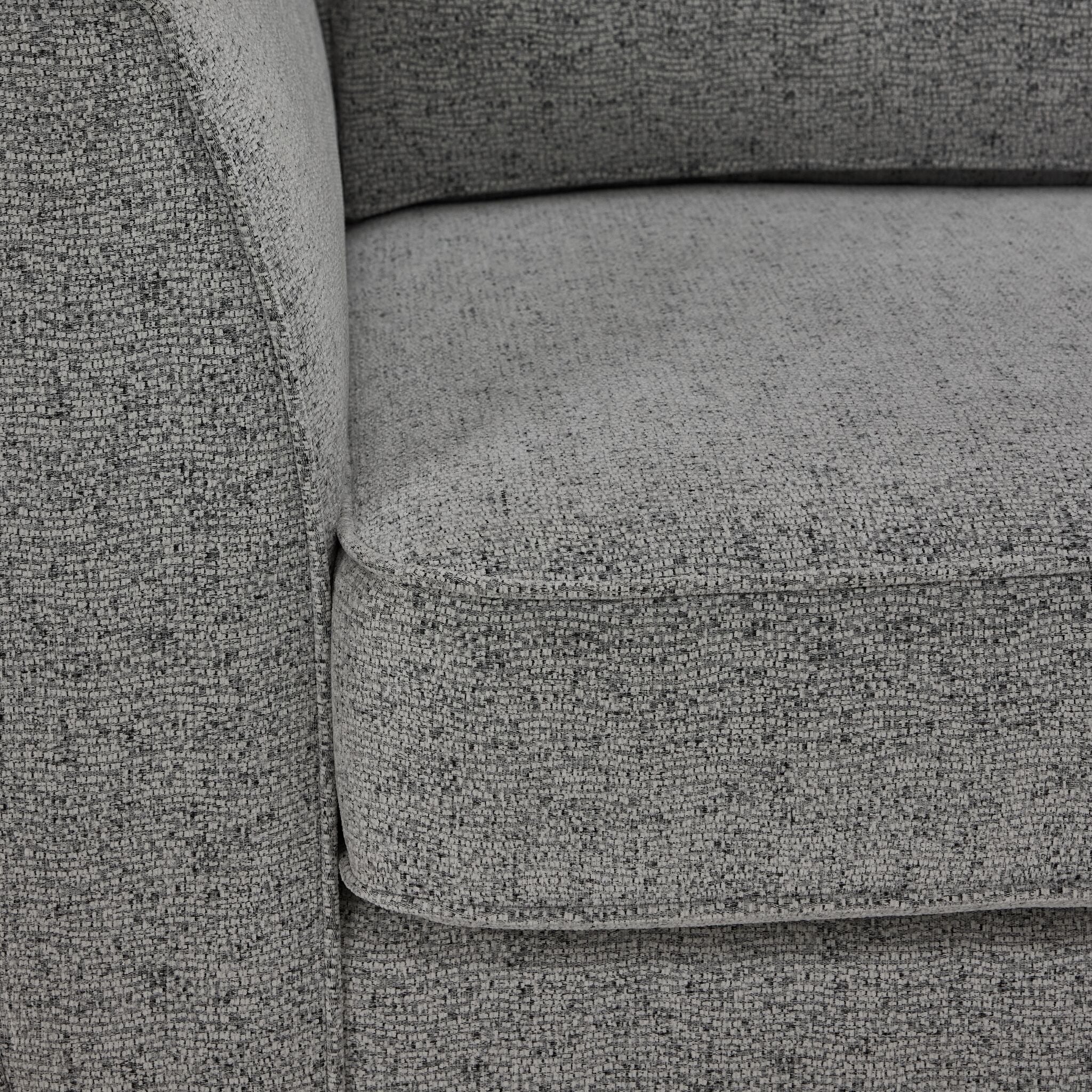 Moncton loveseat close-up showing light grey polyester upholstery, cushion edge and seam detail