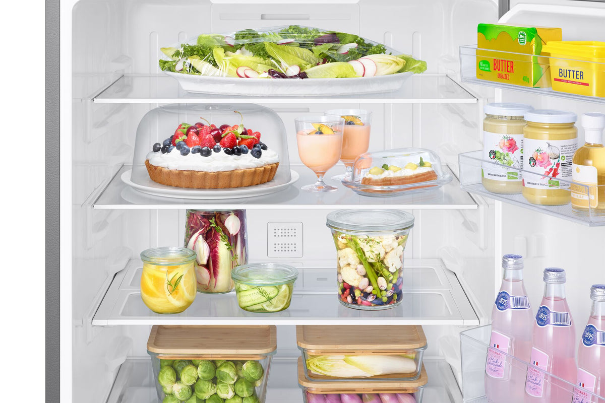 Samsung 28" bottom mount refrigerator interior close-up showing glass shelves, food containers and clear door bins