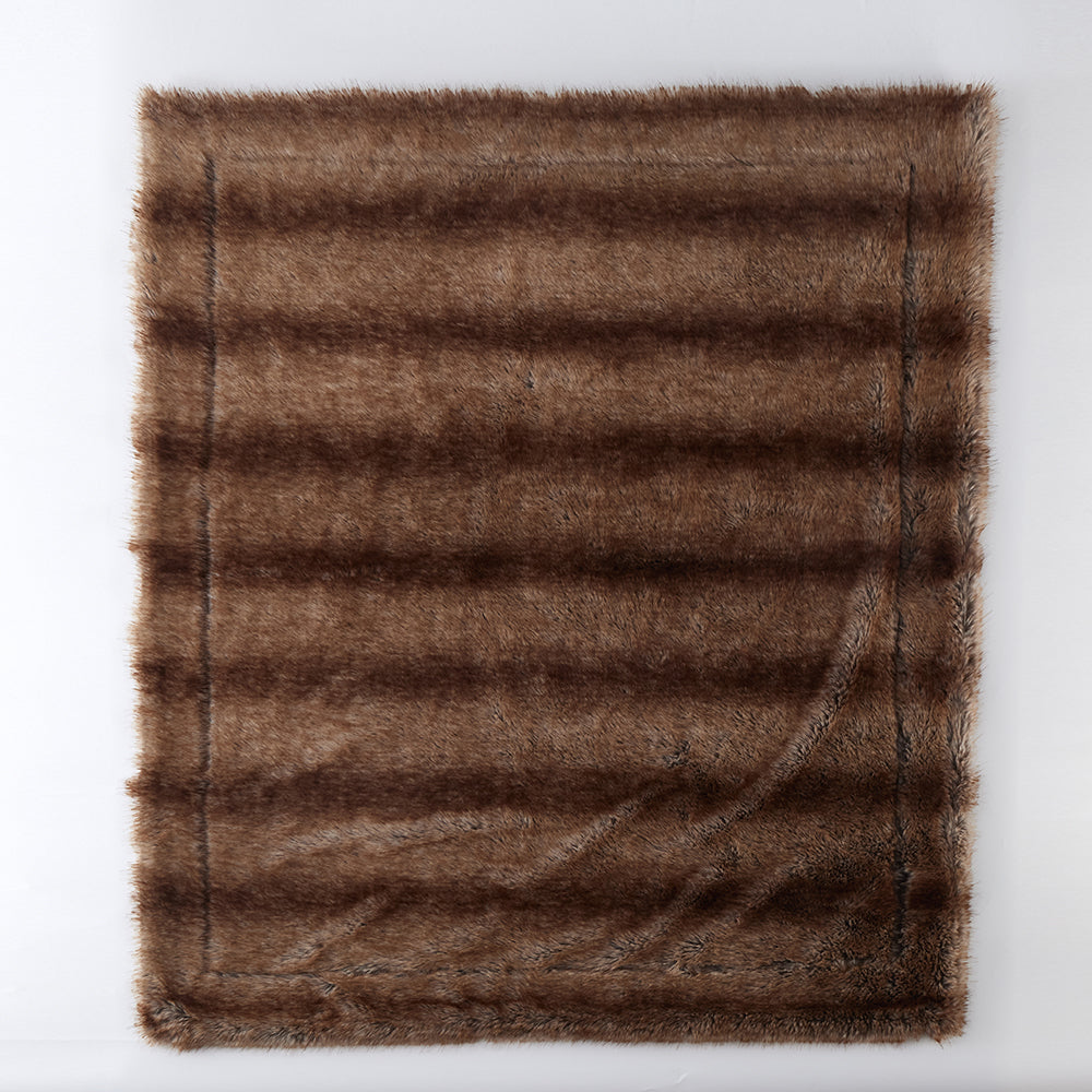 Front view of The Great Indoors 50 x 60" light brown faux fur throw laid flat, showing the faux fur front.