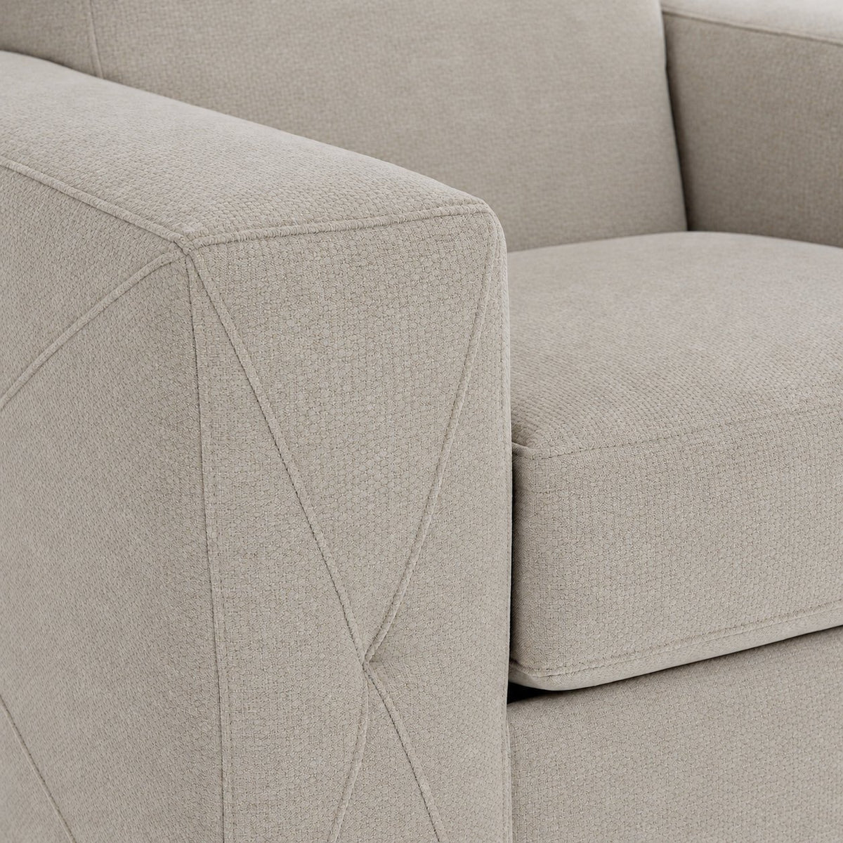 Valetta ivory upholstery close-up showing textured fabric and decorative cross stitching on the wide track arm