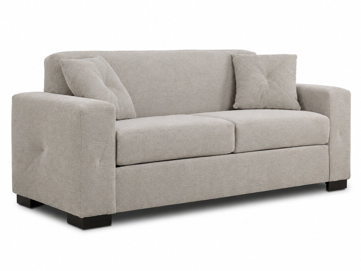 Valetta Sofa - Ivory angled view with two seat cushions, wide track arms, dark block feet and two accent pillows
