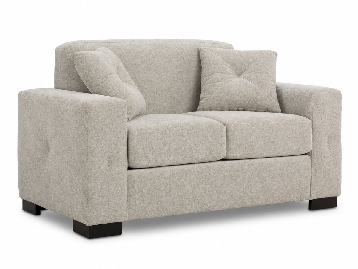 Valetta Loveseat - Ivory angled view with two seat cushions, wide track arms, dark block feet and two accent pillows
