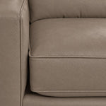 Close-up of the City Leather collection in Stone showing textured leather upholstery, piped cushion edges and stitching