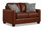City Leather Loveseat - Brown in a three-quarter view with two cushioned seats, slim track arms, dark wood legs and two patterned accent pillows