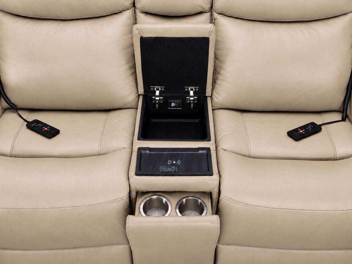 Jackson loveseat centre console close-up showing open storage, wireless charging pad, cupholders and remotes