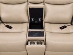 Jackson loveseat centre console close-up showing open storage, wireless charging pad, dual cupholders and remotes