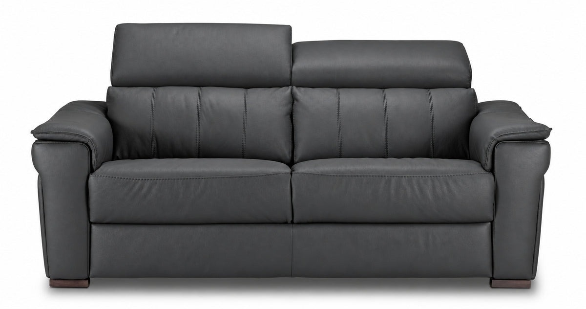 Dark grey leather sofa with one headrest raised and the other lowered to show adjustable positioning