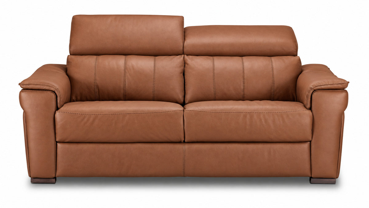 Cognac leather sofa with one headrest raised and the other lowered