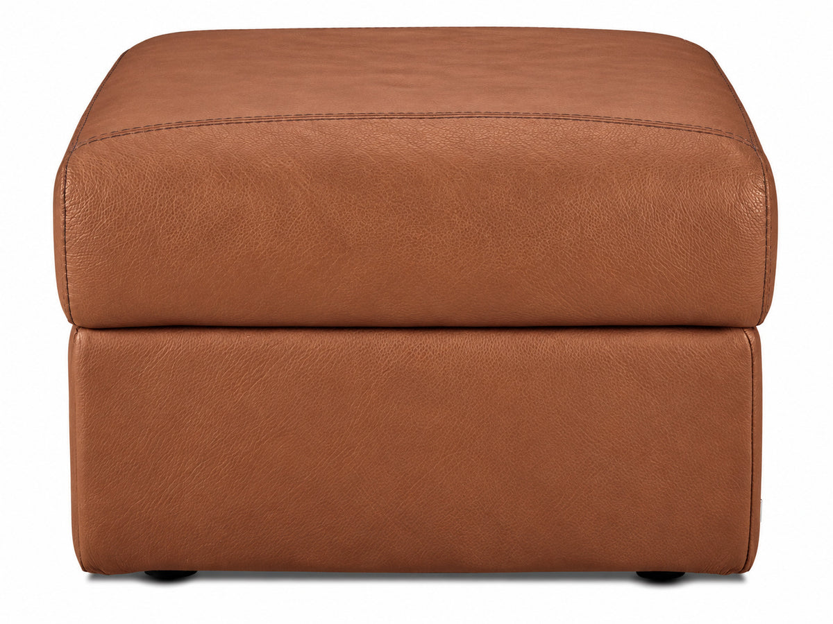 Front view of the cognac leather ottoman with thick padded top and low-profile feet