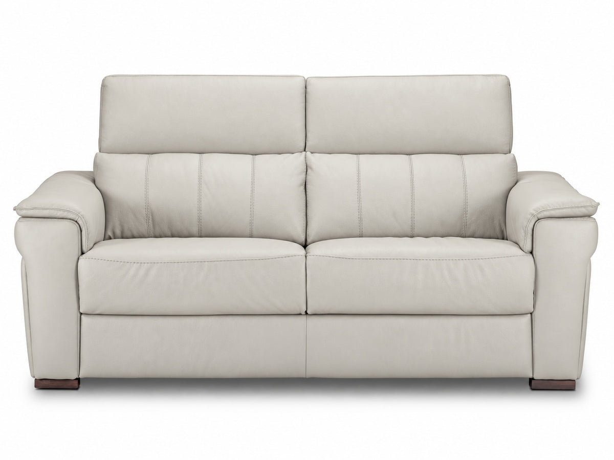 Front view of the cream leather sofa showing two seat cushions and stitched backrests