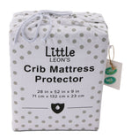 Little Leon’s crib mattress protector in white polka-dot drawstring packaging with 28 x 52 x 9 inch sizing