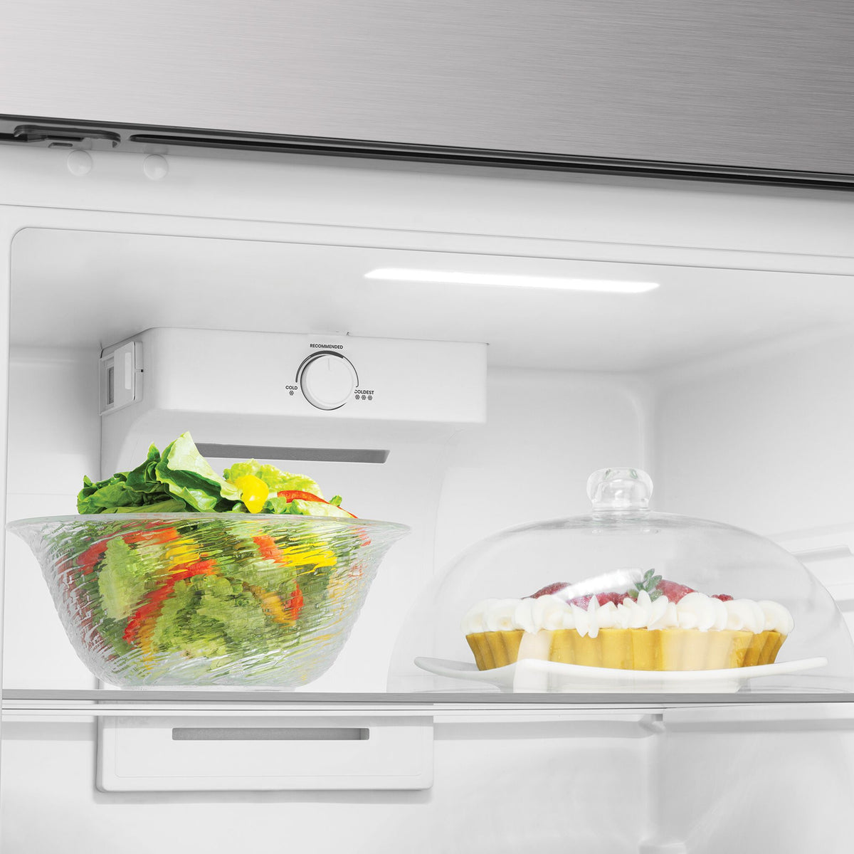 Refrigerator interior with temperature control, LED lighting and glass shelf storage.