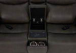 Jackson loveseat centre console close-up showing open storage, wireless charging pad, dual cupholders and remotes