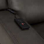 Jackson anthracite leather recliner close-up showing wired remote for power recline, heat and massage controls