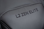 Close-up of the L2 Zen Elite branding embroidered on the black padded massage chair headrest