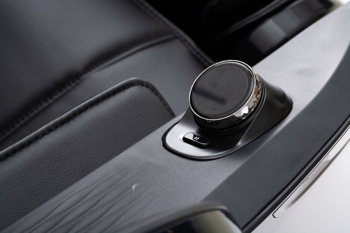 Close-up of the L2 Zen Elite Massage Chair round control dial and adjacent button on the armrest