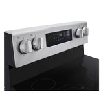 Close-up of LG electric range stainless steel control panel with burner knobs and central digital display