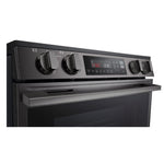 Close-up of LG induction range front controls with four knobs, digital display and oven cooking settings