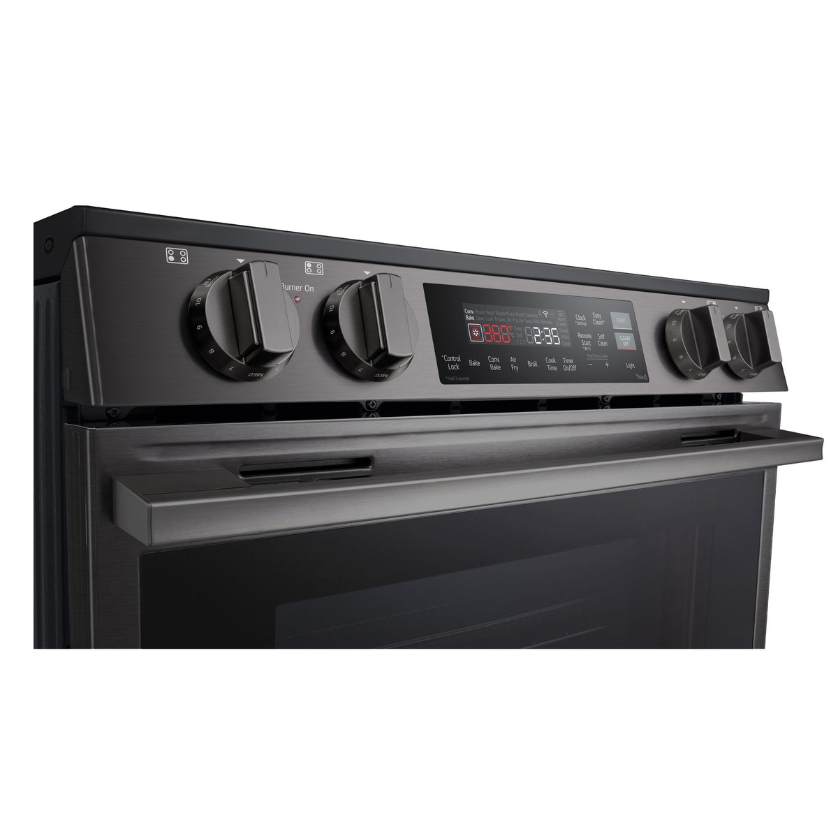 Close-up of LG induction range front controls with four knobs, digital display and oven cooking settings