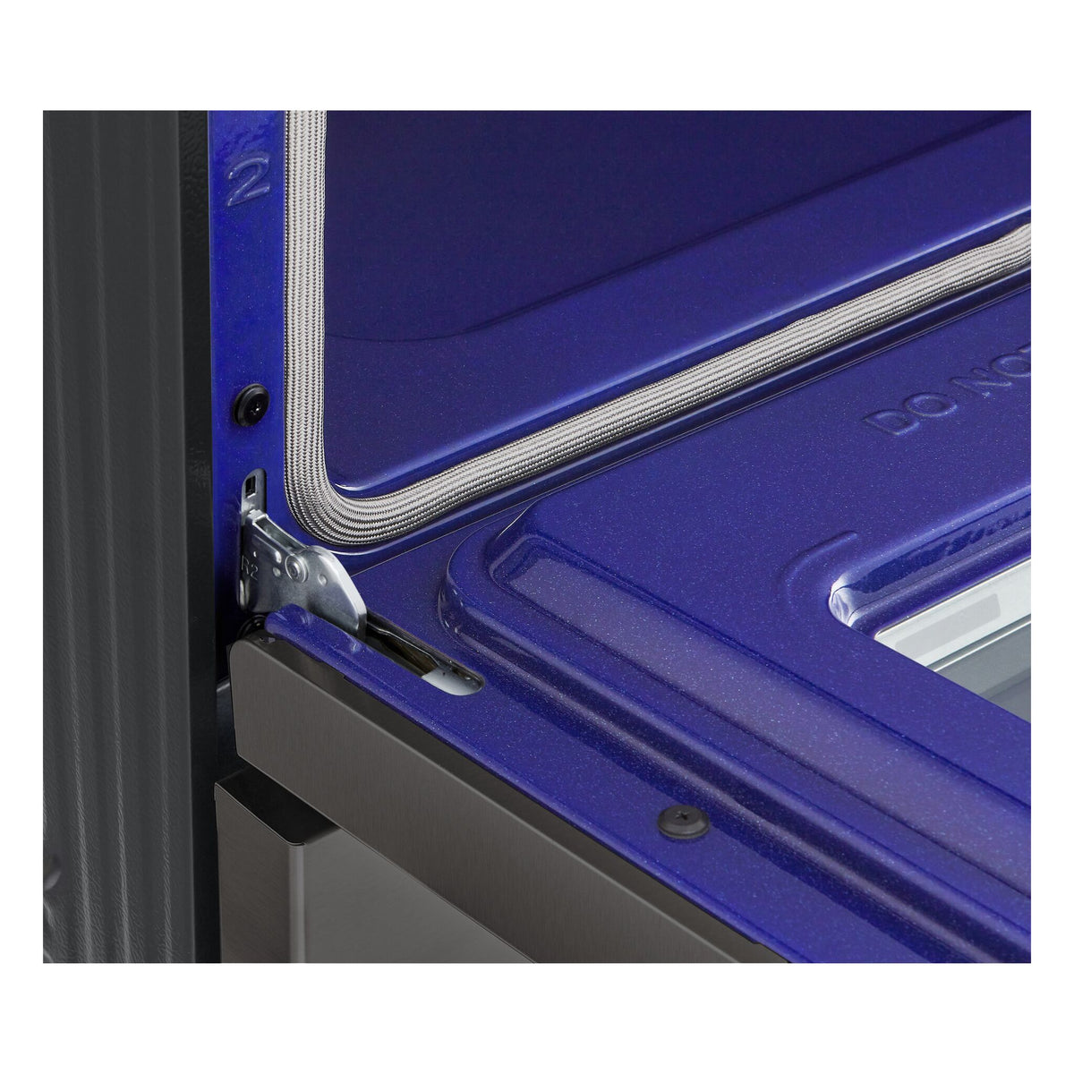 Close-up of LG range blue oven interior showing enamel finish, door hinge and braided oven gasket