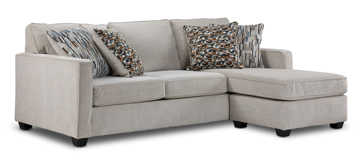 Laila reversible sofa chaise in beige polyester with transitional styling, patterned pillows and right-side chaise