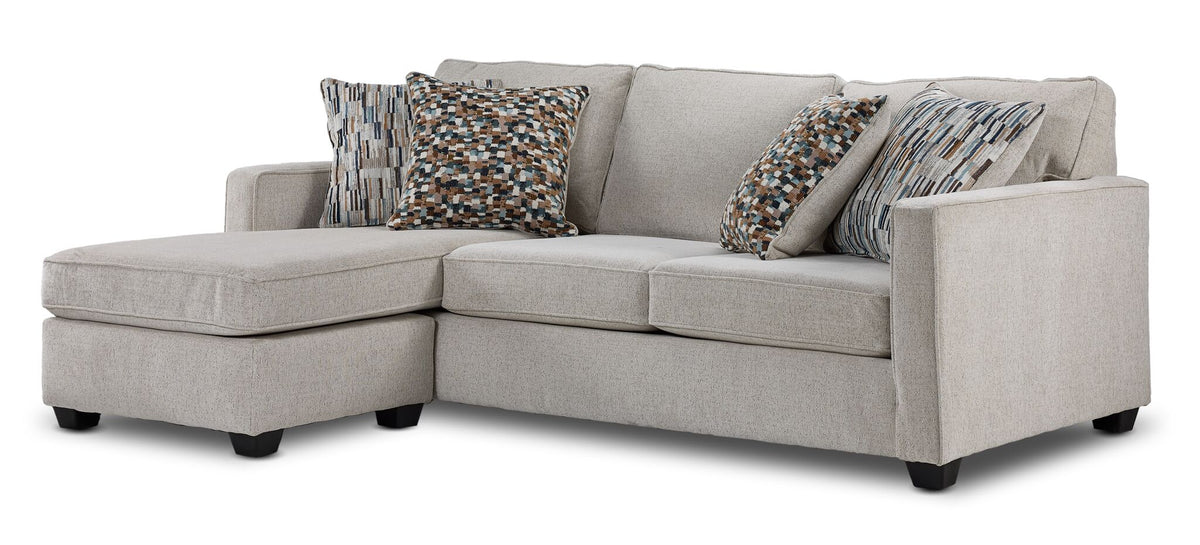 Laila reversible sofa chaise in beige polyester with transitional styling, patterned pillows and left-side chaise