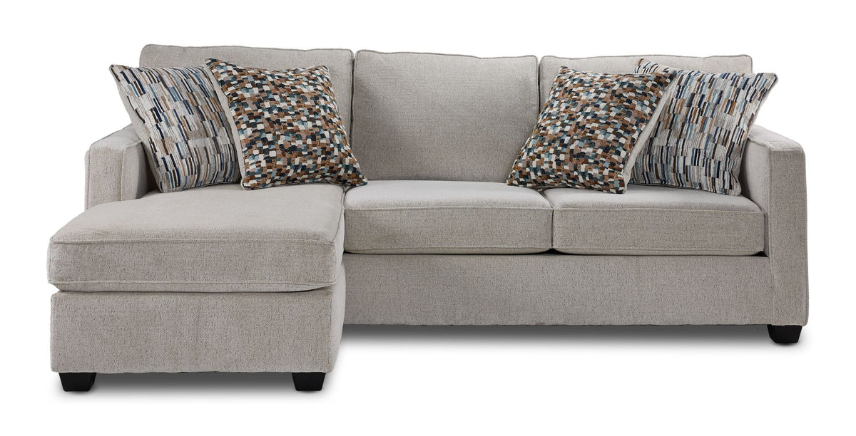Front view of Laila beige polyester sofa chaise with patterned accent pillows and chaise positioned on the left