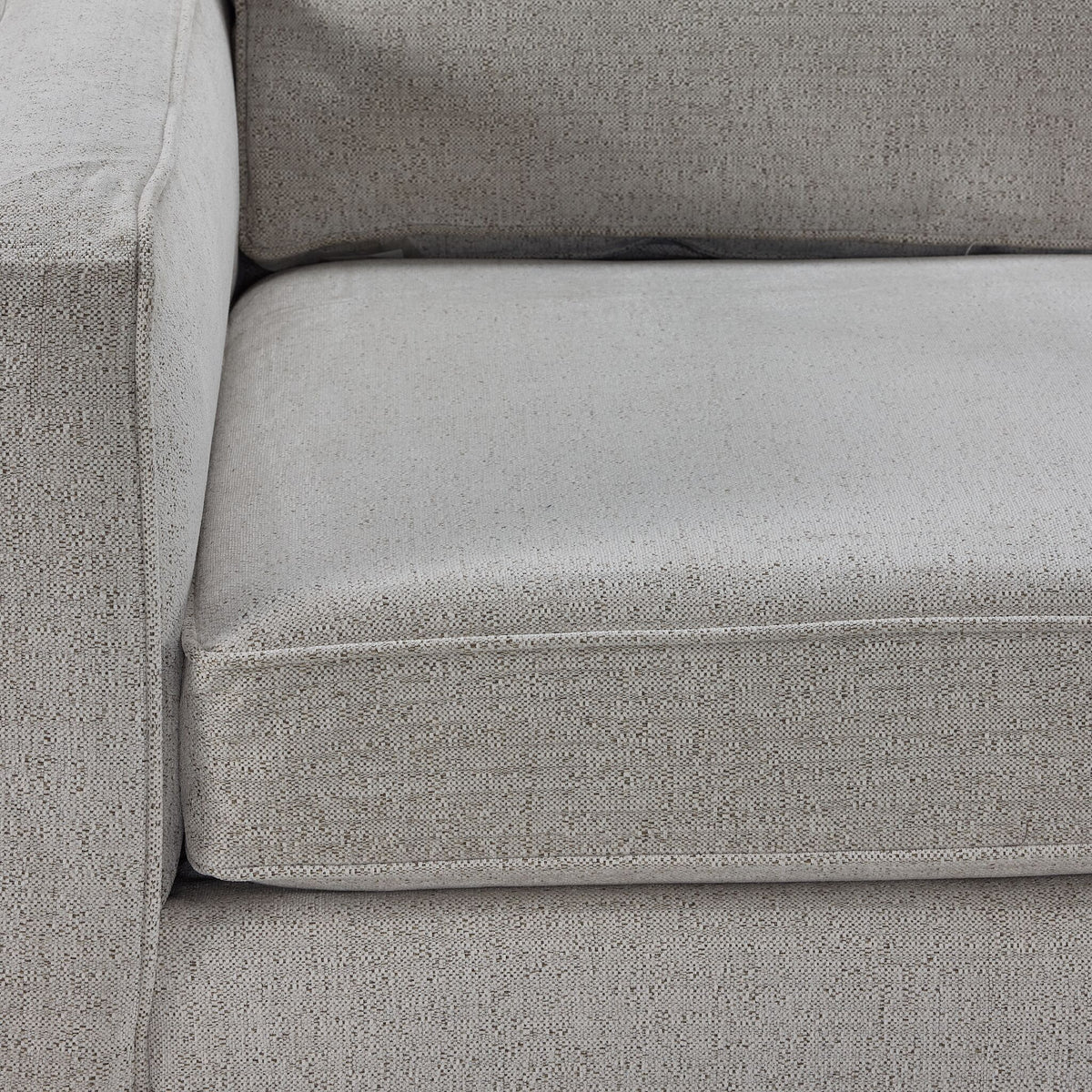 Close-up of the Laila sofa chaise beige 100% polyester upholstery showing its finely woven texture