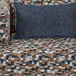 Front view of Laila swivel accent chair with multicolour upholstery, cushioned seat and blue lumbar pillow