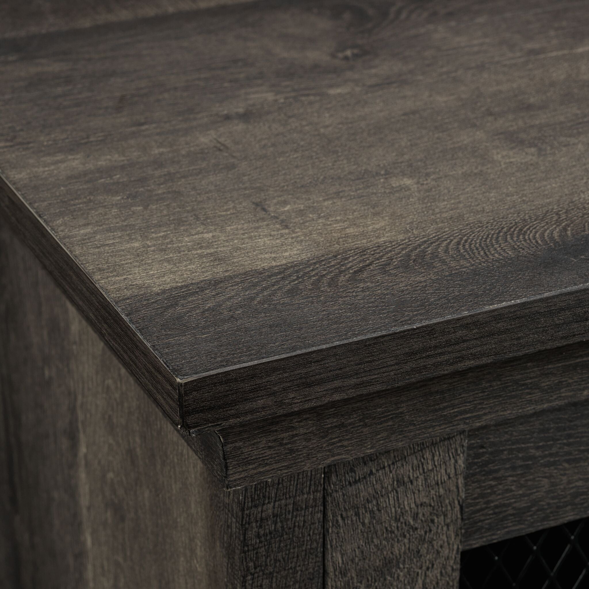 Close-up of Millbrook Fireplace TV Stand showing the textured Fawn Aged Oak wood top and layered edge detail