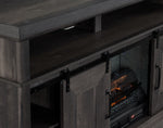 Close-up of Preston charcoal Fireplace TV Stand showing black sliding barn door hardware, open shelf and fireplace insert