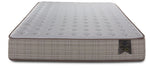 Front view of the Twin mattress highlighting the tufted white surface, brown piping and Origins label