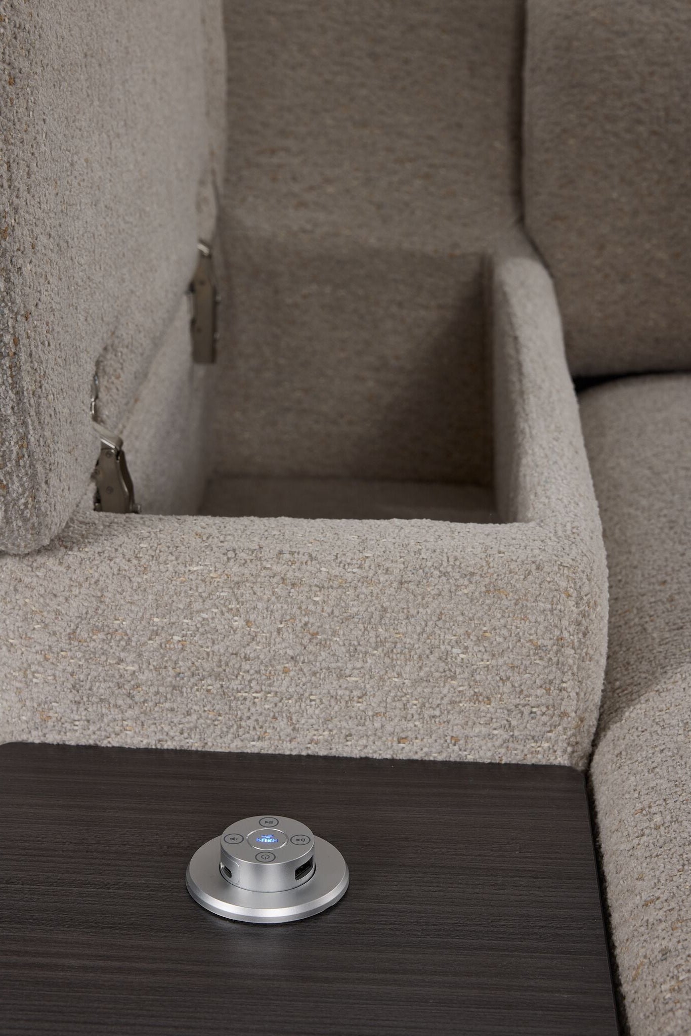 Close-up of Slayden right-facing taupe sectional showing open arm storage, side table and USB control panel