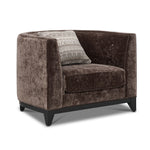 Tresor dark brown chair with curved back, button-tufted detail, accent pillow and angled front view