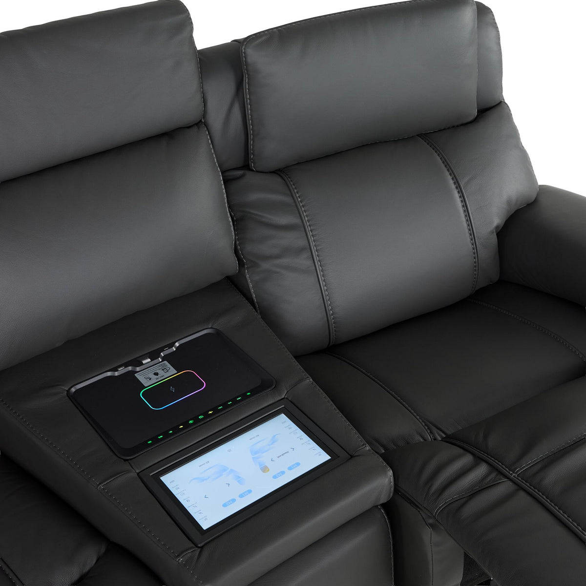 Velocity dark grey leather seating close-up showing padded headrest, touchscreen console and wireless charging pad