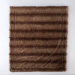 Front view of The Great Indoors 50 x 60" light brown faux fur throw laid flat, showing the faux fur front.