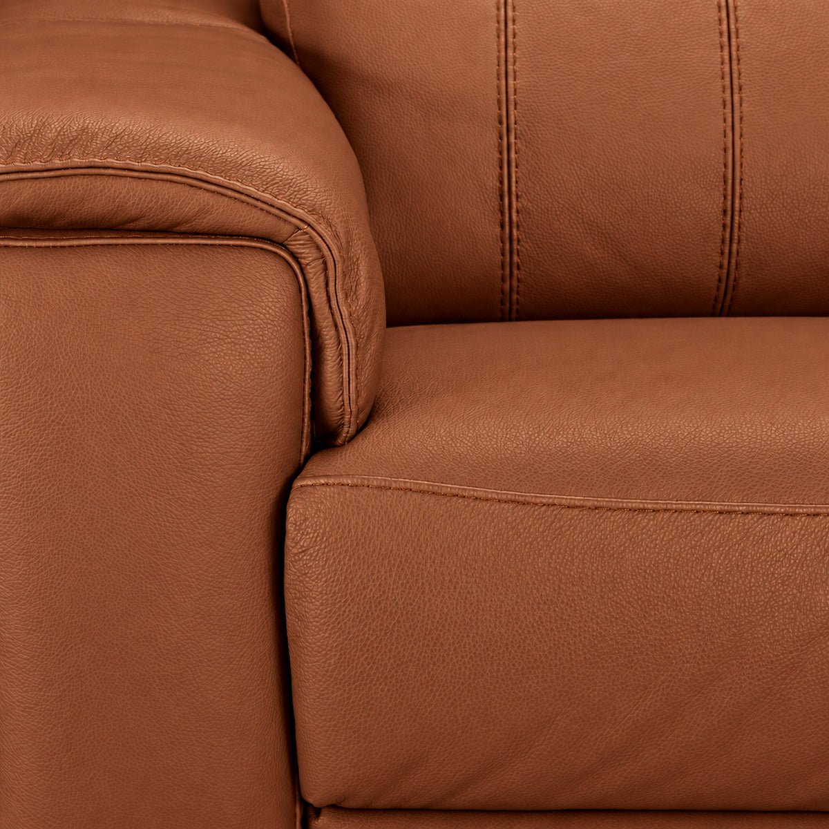 Close-up of cognac leather texture, stitching, cushioned arm and seat