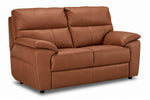 Matching two-seat leather loveseat with plush back cushions and deep seating