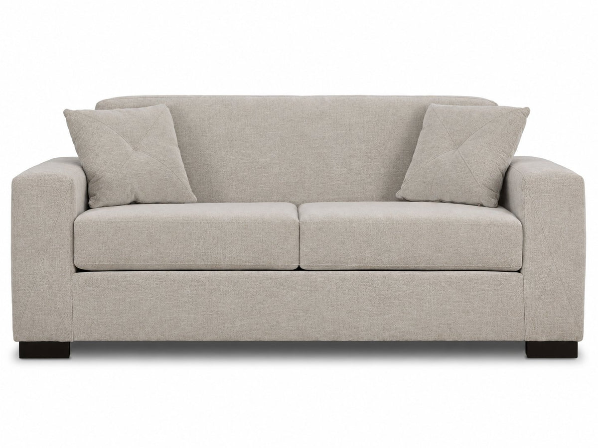 Valetta Sofa - Ivory front view with two seat cushions, wide track arms, dark block feet and matching accent pillows